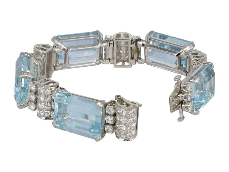 Platinum flexible vintage bracelet consisting of 5 emerald cut aquamarines having a total weight of approximately 100 carats set with approximately 5.00 carats total weight of round brilliant cut diamonds, circa 1950.