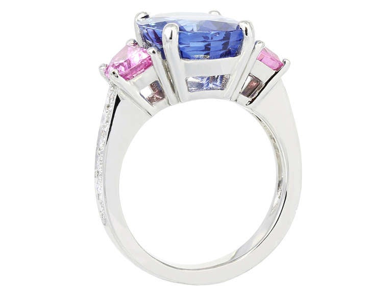 Platinum custom made three stone style ring consisting of 1 cushion cut Ceylon sapphire, weighing 7.10 carats, measuring 12.50 x 10.72 x 6.13 mm with GIA report 5151229433 stating Sri Lanka as the origin and flanked by 2 half moon shape pink
