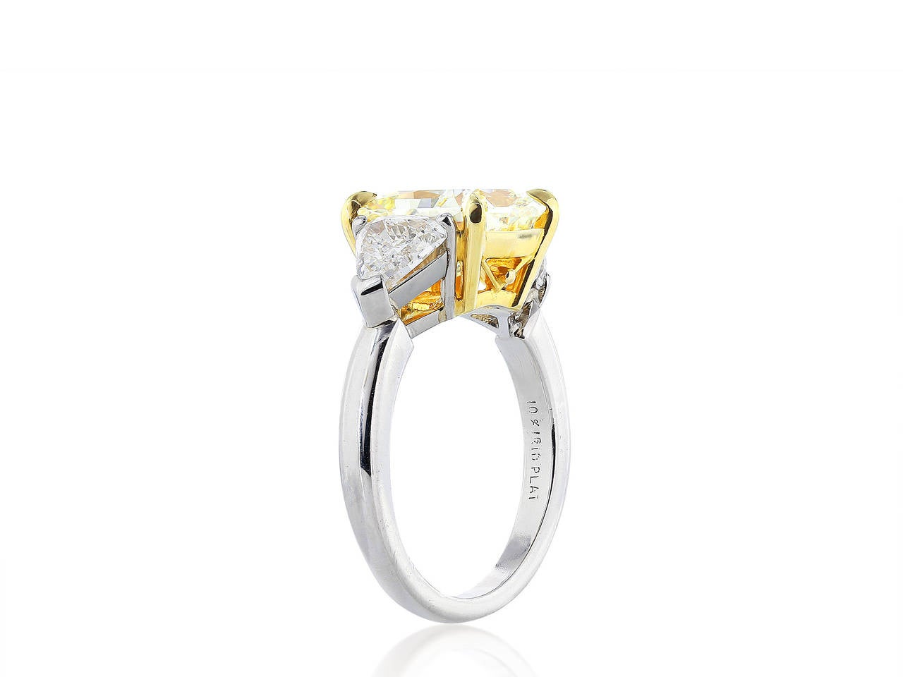 Platinum and 18 karat yellow gold custom made 3 stone ring consisting of 1 radiant cut, natural canary diamond center stone weighing 3.64 carats, with a color and clarity of fancy yellow/VS2, measuring 9.21 x 8.56 x 5.16 mm, with GIA cert #15614540,