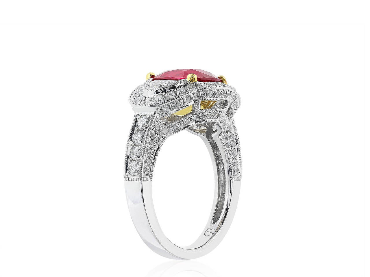 18 karat white gold 3 stone ring consisting of 1 cushion shape ruby weighing 2.55 carats, with AGL certificate, the center stone is flanked by 2 brilliant cut half moons having a total weight of 1.00 carats, the 3 stone stones are set with additinal