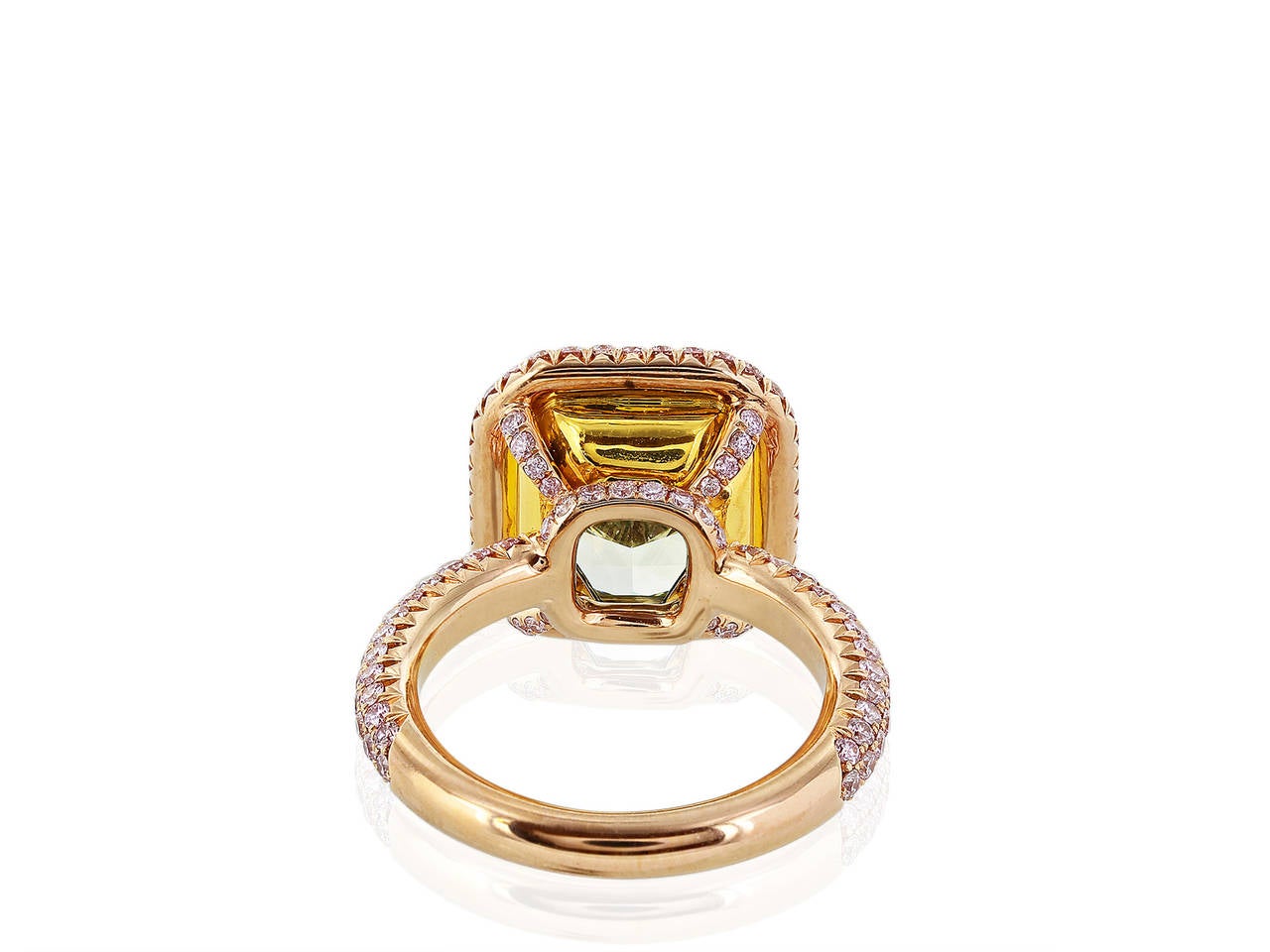 18 karat pink gold ring consisting of rectangular radiant cut diamond weighing 7.08 carats having a color and clarity of Fancy intense Green-Yellow / VS2 with GIA certificate, the center stone is set with 175 full cut fancy pink diamonds having a