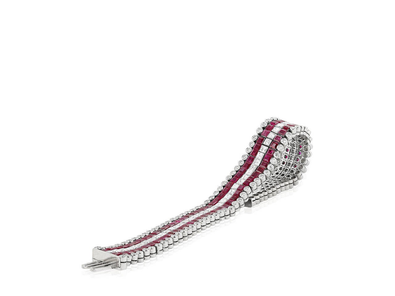 Platinum 5 row flexible bracelet consisting of 116 invisible set square cut rubies having a total weight of 30.00 carats set with 58 square cut diamonds and 116 bezel set round brilliant cut diamonds having a total weight of 14.20 carats.  Signed