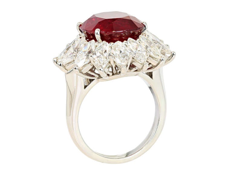 Platinum cluster ring consisting of 1 cushion cut Thai ruby weighing 10.33 carats, measuring 12.54 x 11.91 x 7.90mm with GIA certificate 2151270828, the center stone is surrounded by 1 row of marquise shape diamonds having a total weight of
