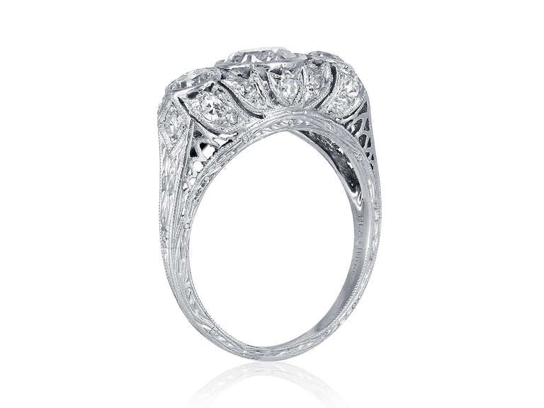 Platinum Edwardian ladies three stone filigree dome ring consisting of 3 Old European cut diamonds having a total weight of approximately 1.85 carats,