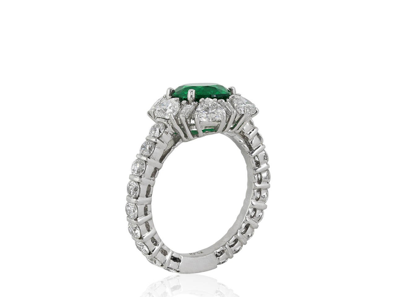 Platinum cluster ring consisting of 1 round brilliant cut Colombian emerald weighing 2.02 carats set with 2.86 carats total weight of round brilliant cut, heart shape and baguette diamonds.