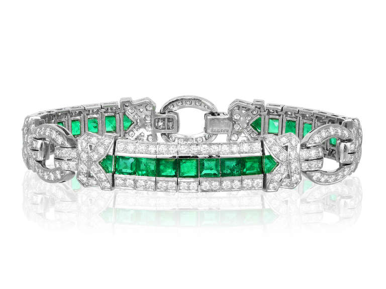 Estate platinum  Bracelet consisting of channel set caliber cut emeralds having an approximate total weight of 8.00 carats and bead set round brilliant cut diamonds having an approximate total weight of 3.63 carats.