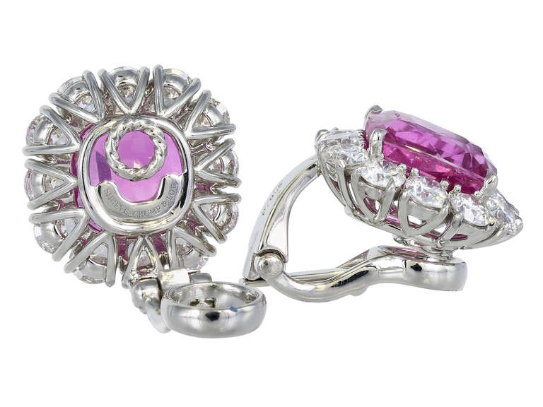Platinum custom made cluster earrings consisting of 2 fine pink unheated sapphires having a total weight 9.44 carats with GIA certificate stating No Heat, the center stones are surrounded by 48 round brilliant cut diamonds having a total weight of