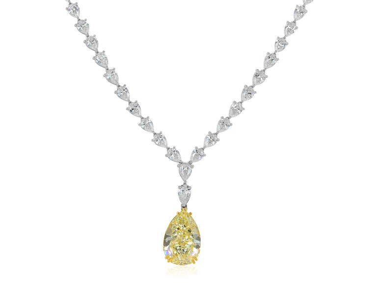 Custom made 18 karat white and yellow gold necklace, consisting of 1 pear shape natural canary diamond drop, weighing 15.98 carats, measuring 19.98 x 13.42 x 8.37 mm, a color and clarity of Fancy Light Yellow/VS2 with GIA report number 2155873355