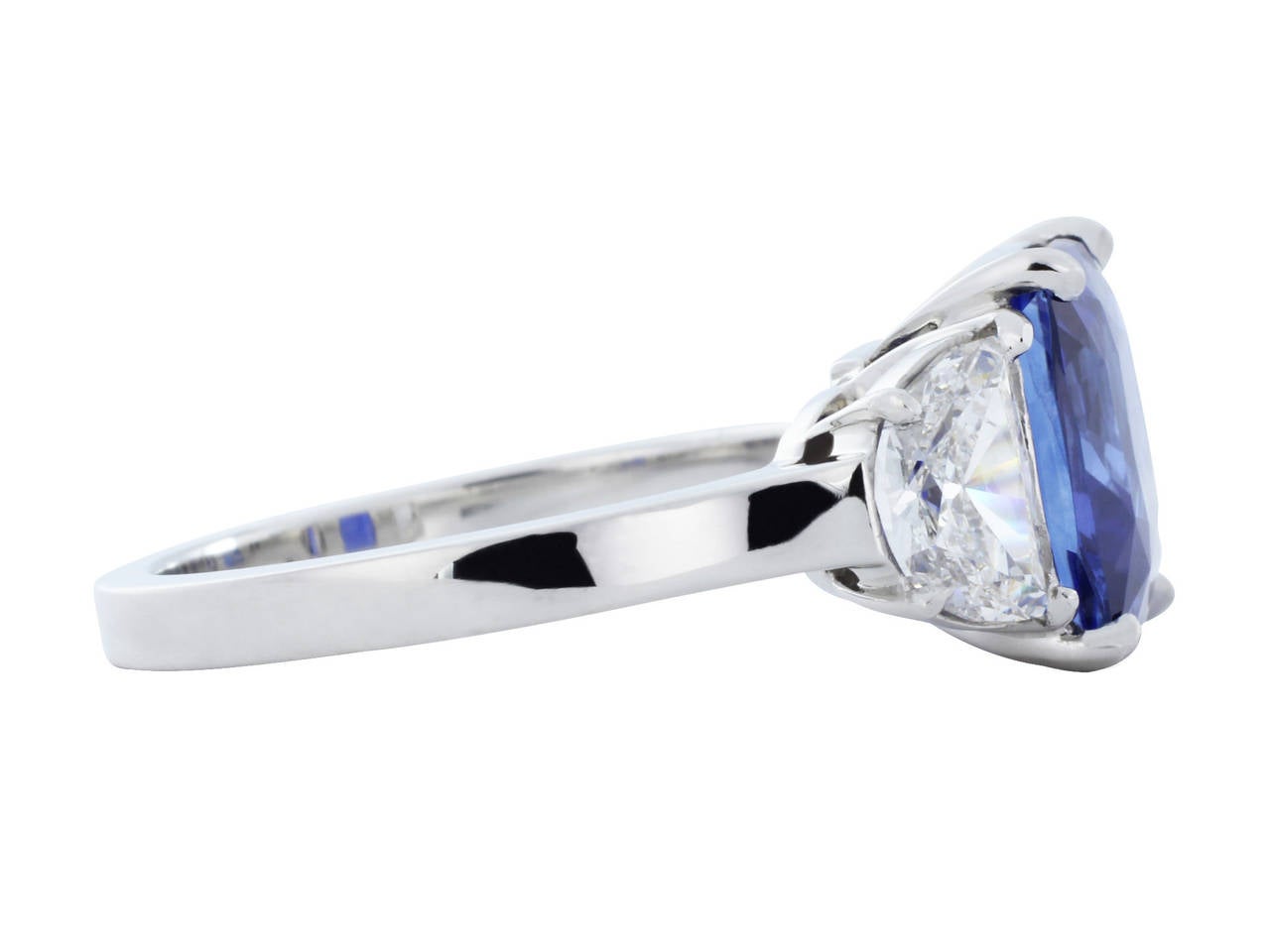 A true rara avis, this platinum custom made 3 stone ring, features 1 cushion cut No Heat Burma sapphire weighing 4.13 measuring 9.22 X 8.08 X 5.66mm, with AGTA certificate number 91002907 and GIA certificate number 210505209467 the center stone is