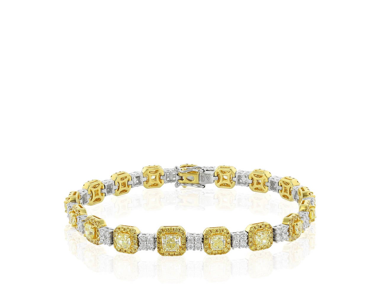 Two tone 18 karat yellow and white gold flexible bracelet consisting of 1.39 carats total weight of colorless round brilliant cut diamonds, 1.75 carats total weight of round brilliant cut canary diamonds and 3.39 carats total weight of radiant cut