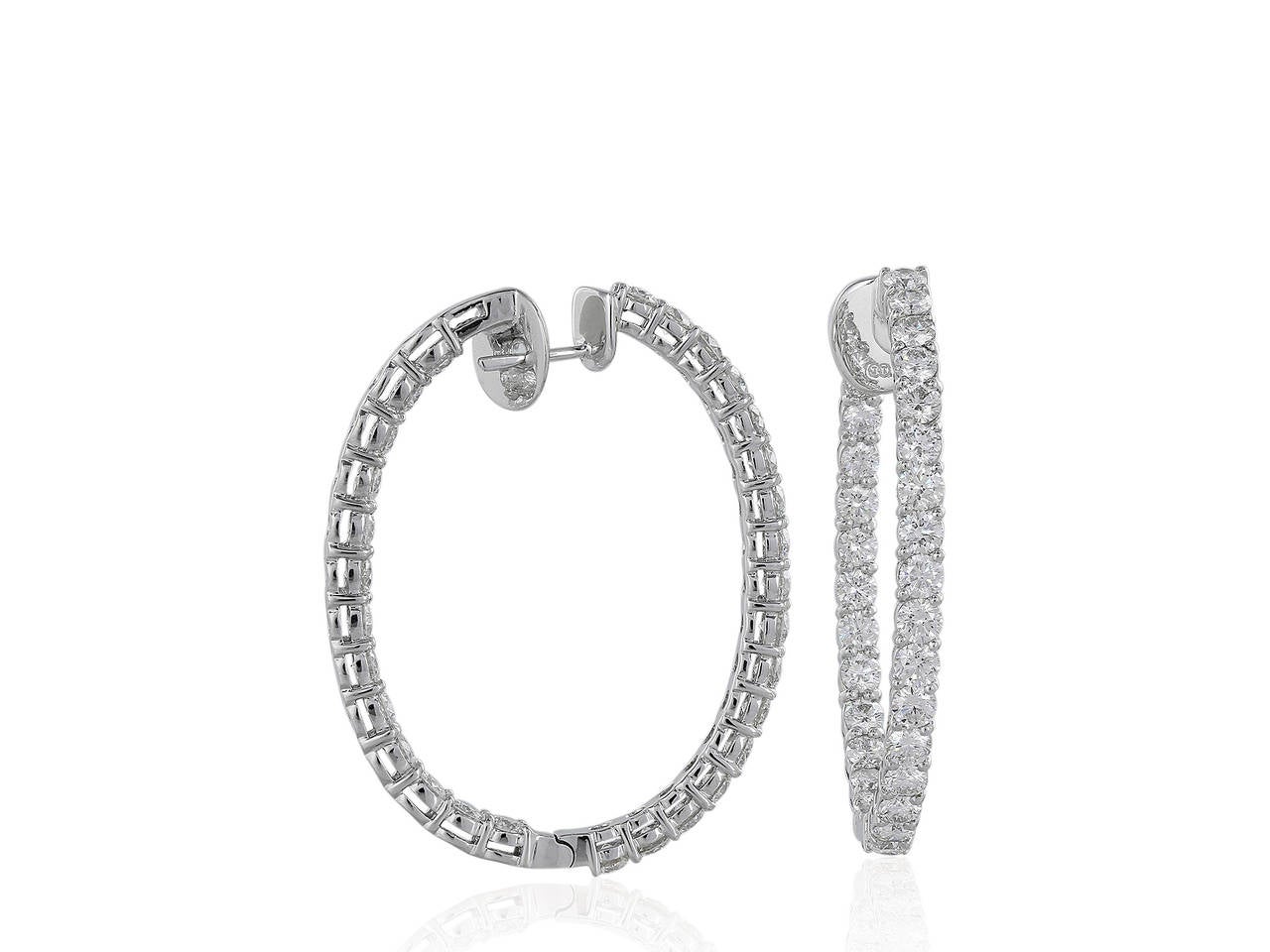 18 karat white gold oval shaped hoop earrings consisting of 60 round brilliant cut diamonds having a total weight of 8.05 carats.
