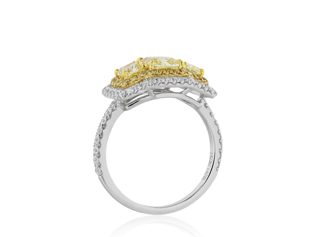 Two tone 18 karat yellow and white gold 3 stone ring consisting of consisting of 1 radiant cut canary diamond 1.24 carats having a color and clarify of FY/SI2 with GIA certificate #1162231615, the center stone is flanked by 2 radiant cut canary