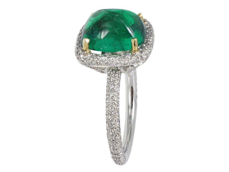 Platinum solitaire ring consisting of 1 cabochon Colombian emerald weighing 4.01 carats with, the center stone is set with 1.09 carats total weight of full cut diamond accents.