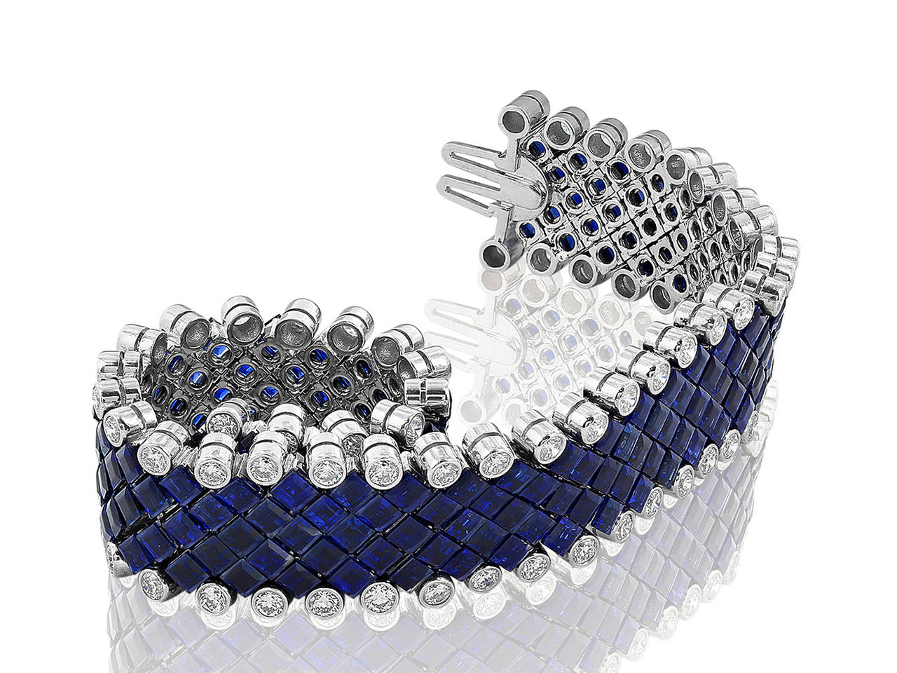 Platinum flexible bracelet consisting of 40.00 carats total weight of invisible set blue sapphires set with 80 bezel set round brilliant cut diamonds having a total weight of 5.60 carats.  Signed Aletto Brothers for Shreve, Crump & Low.