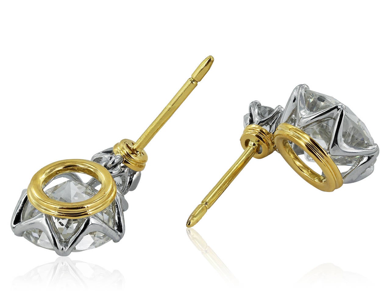 Platinum and 18 karat yellow gold antique style drop earrings consisting of 2 old European cut diamonds having a total weight of 5.65 carats with an approximate color and clarity of H-I/SI1. The 2 diamonds drop from 2 Old European cut diamonds