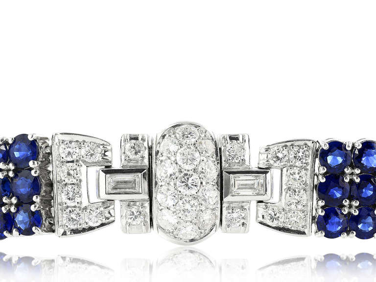 Platinum flexible bracelet consisting of approximately 10.00 carats total weight of full cut sapphires set with approximately 4.75 carats total weight of round brilliant cut diamonds.