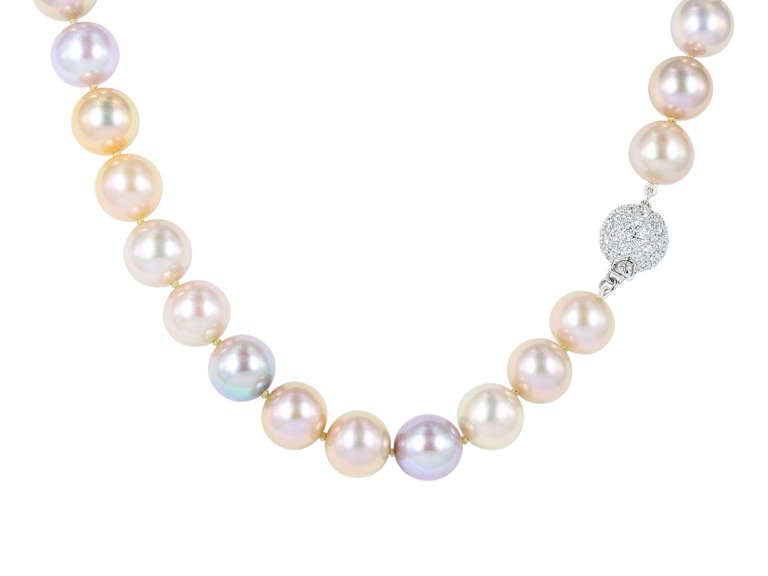 18 karat white gold, hand strung pearl necklace, consisting of 38 multi color natural freshwater pearls measuring around 10.64-11.26mm and finished with a full cut round pave diamond clasp having a total weight of 1.55 carats.