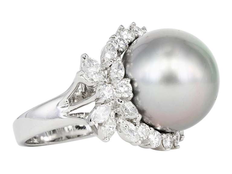 18 karat white gold ring cluster style ring consisting of 1 gray South Sea Pearl measuring around 16.30 mm, surrounded by 14 round brilliant cut diamonds, and 16 marquise shaped diamonds, all having an estimated total weight of 1.90 carats.