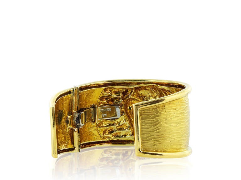 18 karat yellow gold estate bangle bracelet with high relief bull, signed David Webb