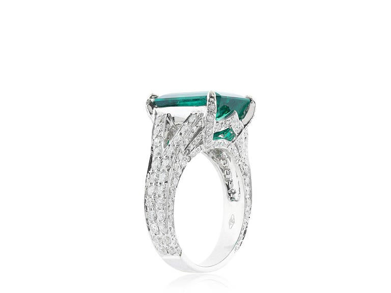 Platinum emerald and diamond ring consisting of one rectangular emerald cut emerald weighing 6.25 carat with AGL certificate # CS8314 stating Colombia origin with minor enhancement, the stone is set with a split shank mounting with full diamonds