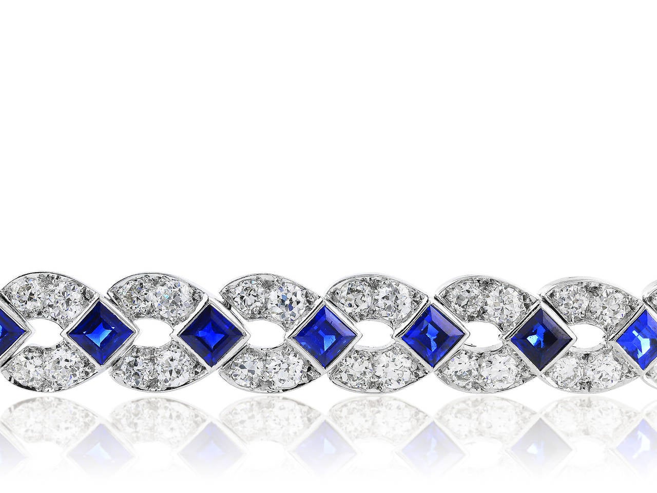 Platinum Art Deco bracelet consisting of approximately 10.25 carats total weight of Old European Cut Diamonds set with approximately 10.00 carats total weight of Square Cut Sapphires.