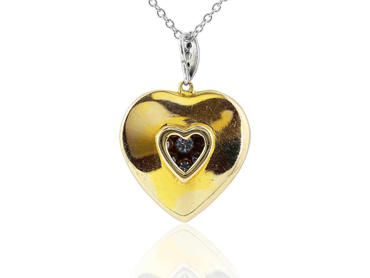 Estate Two tone 18 karat yellow and white gold heart shape pendant pave set with full cut diamond accents having an estimated total weight of 3.00 carats on an 18 inch 18 karat white gold cable link chain.