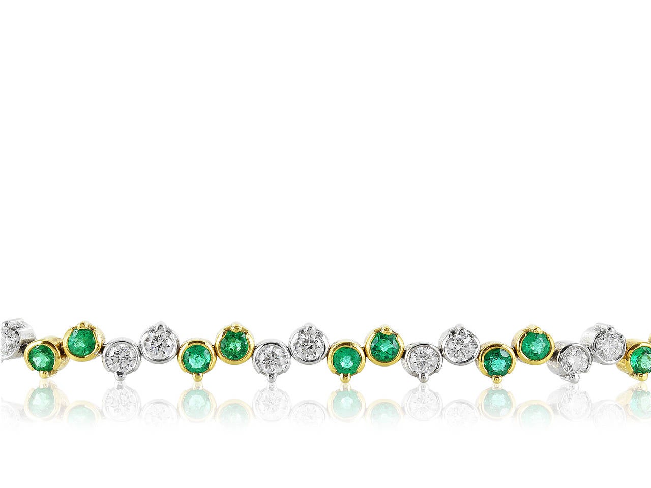 18 karat yellow and white gold emerald and diamond tennis bracelet consisting of round brilliant cut emeralds having a total weight of 2.68 carats and round brilliant cut diamonds having a total weight of 2.48 carats, and an average color and
