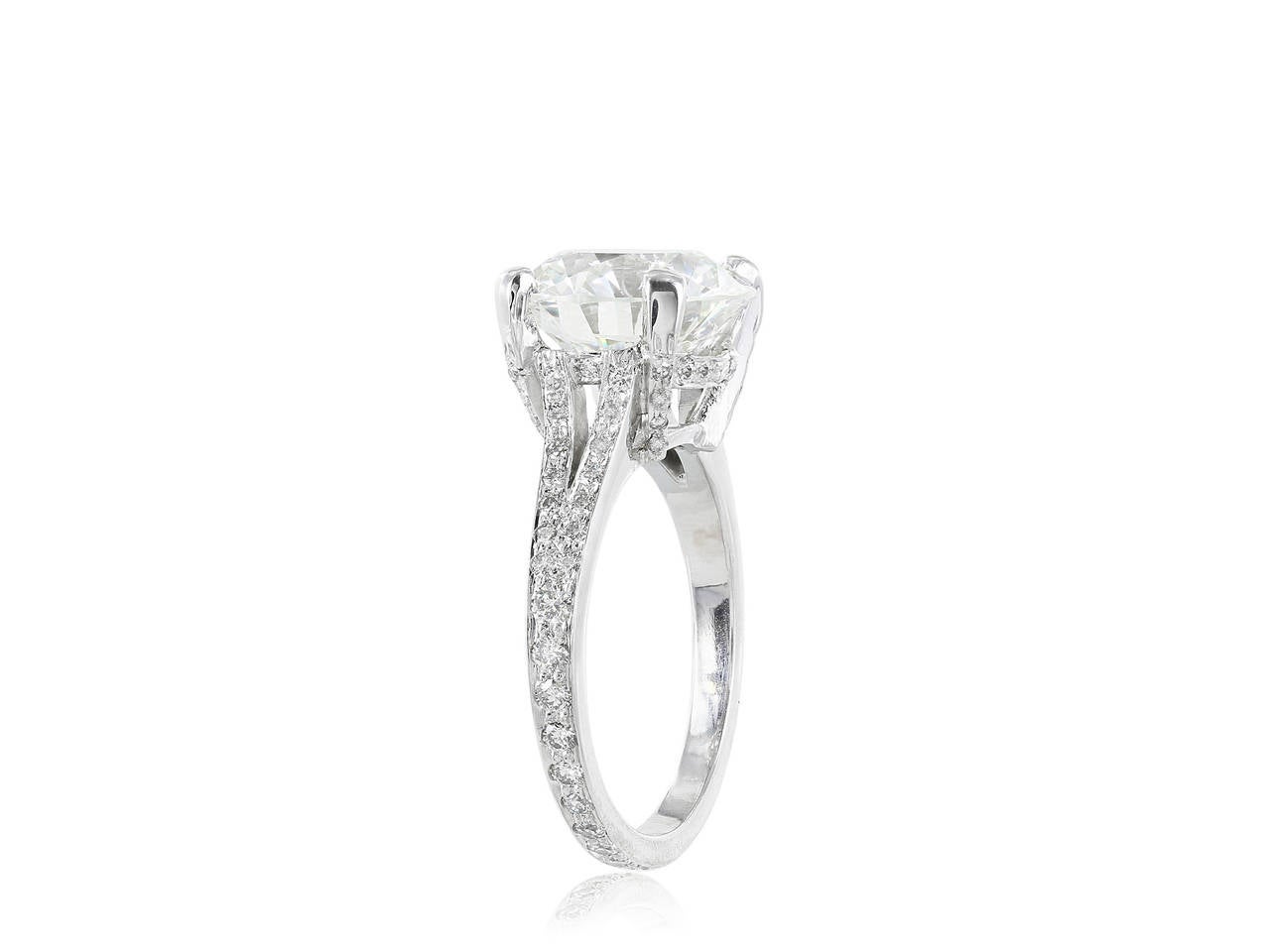 Platinum custom made solitaire ring consisting of one round brilliant cut diamond weighing 5.06 carats, measuring 11.12 - 11.19 x 6.76 mm, having a color and clarity of J/SI1 respectively, triple excellent grades for cut, polish and symmetry with