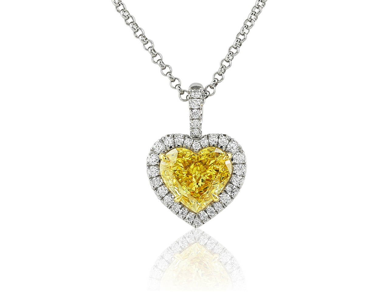 Platinum and 18 karat yellow gold pendant featuring one heart shape canary diamond, weighing 1.15 carats, having a color and clarity of fancy intense yellow/SI1 with a GIA report and accented by full cut white diamond having a total weight of .18
