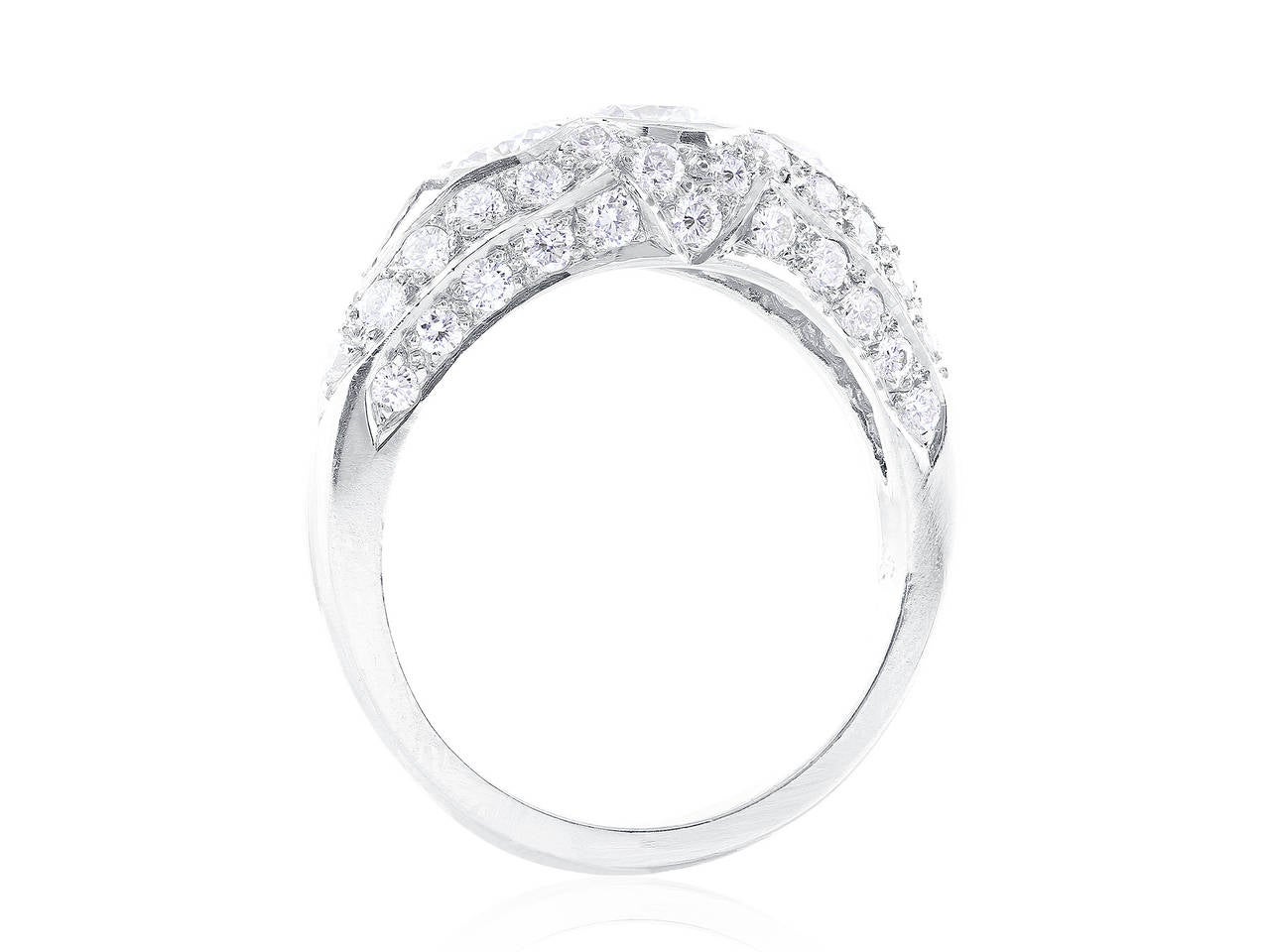 Platinum Art Deco style ring consisting of one bezel set, round brilliant cut diamond weighing .54 carats set with 2 full  cut diamonds having a total weight of 0.51 carat, 2 bezel set, trilliant cut diamonds having a total weight of 0.11 carat and