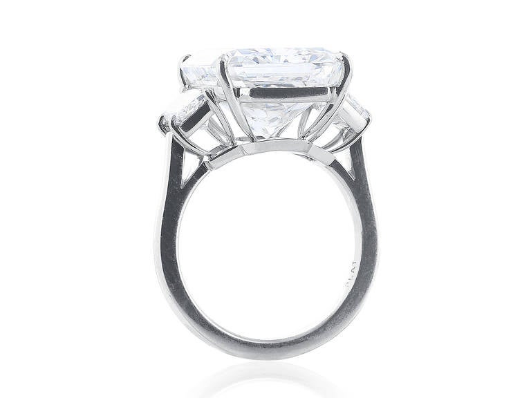 Platinum custom made 3 stone ring consisting of 1 radiant cut diamond weighing 11.29 carats having a color and clarity of F/VS1, with GIA 1102657518.  The center stone is flanked by 2 brilliant cut trapezoid diamonds having a total weight of 1.02