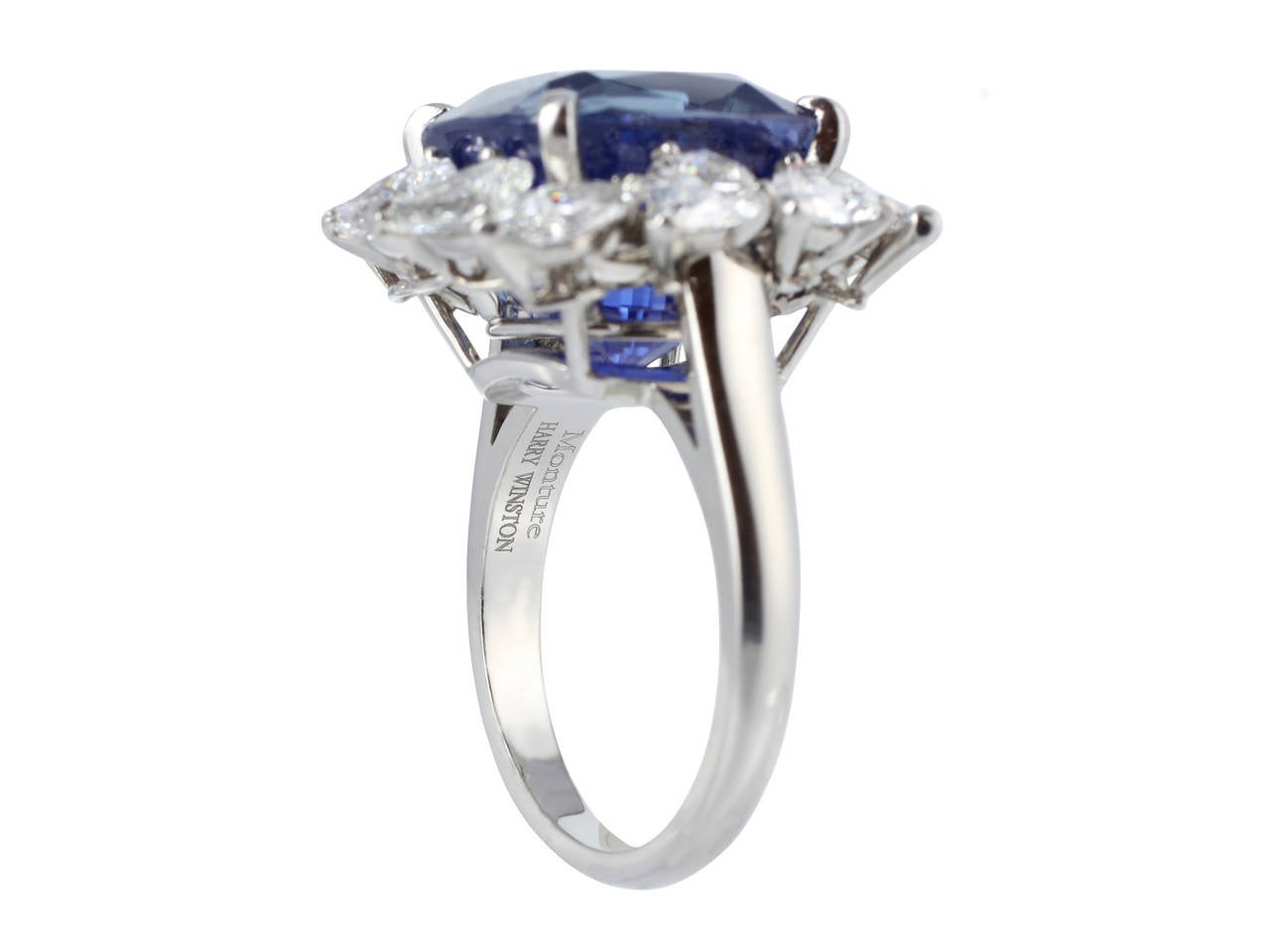 Platinum cluster ring consisting of 1 cushion cut sapphire weighing 16.11 carats, measuring 12.86 x 12.54 x 10.65mm, Madagascar origin with GIA certificate #5151209638. The center stone is surrounded by 1 row of 12 pear shape diamonds having an