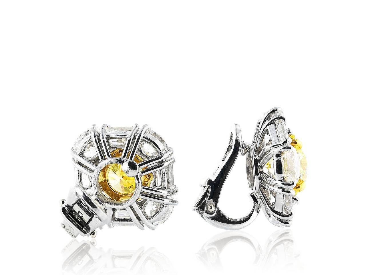 One pair of custom made platinum and 18 karat yellow gold earrings consisting of one natural round brilliant cut canary diamond weighing 1.77 carats having a color and clarity of FY/VS1 with GIA certificate #14460421, and one natural round brilliant