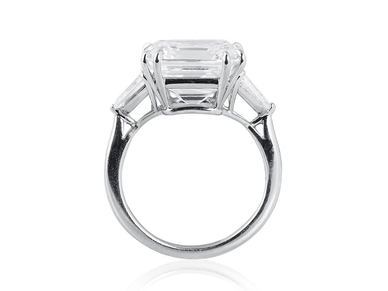 Platinum 3 stone estate ring set with a stunning 8.02ct asscher cut diamond having a color and clarity of G-VS1, with GIA report #5121556626. The center diamond is flanked by two shield cut gem white diamonds totaling 1.5 carats, signed Harry