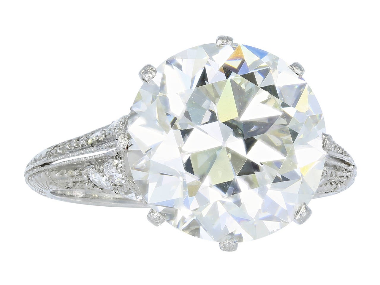 Platinum 8 prong vintage solitaire ring consisting of 1 Old European cut diamond weighing 5.65 carats having a color and clarity of K/VS2 with GIA certificate #5141513999, the stone is set with Old European cut diamond and engraving accents in the