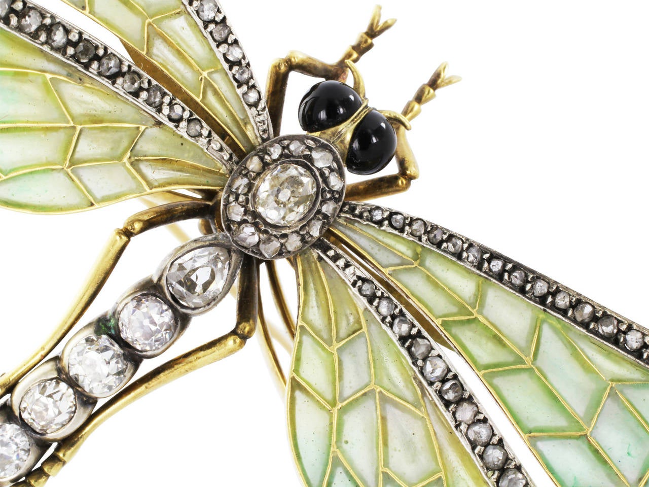 Sterling silver on 18 karat yellow gold antique dragonfly pin with blue - green plique-a-jour wings and antique cut diamond accents in the torso and on the wings and black onyx eyes.