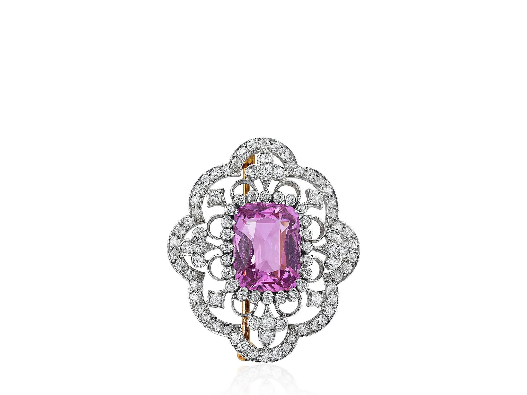 Platinum & 18 karat yellow gold Edwardian pin consisting of 1 cushion cut pink topaz having a total weight of approximately 7.50 carats set with 94 old European cut diamonds having a total weight of approximately 1.50 carats. 