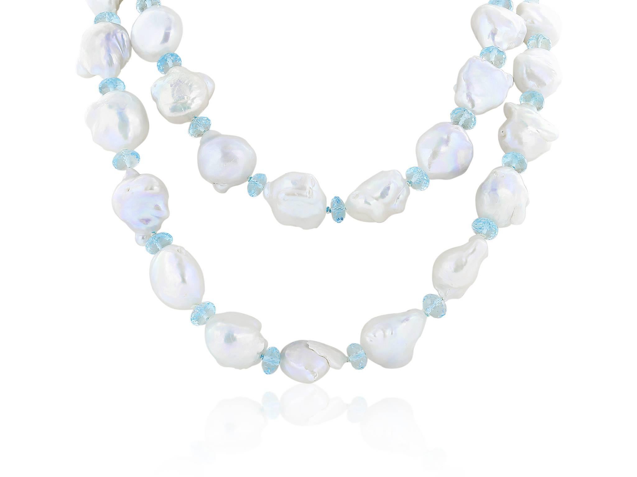 43 inch Baroque, fresh water pearl necklace. The necklace consists of 46 pearls measuring approximately 18.83 x 16.37 mm, each one separated with a faceted aquamarine briolette and has an 18 karat white gold Baroque shaped clasp.