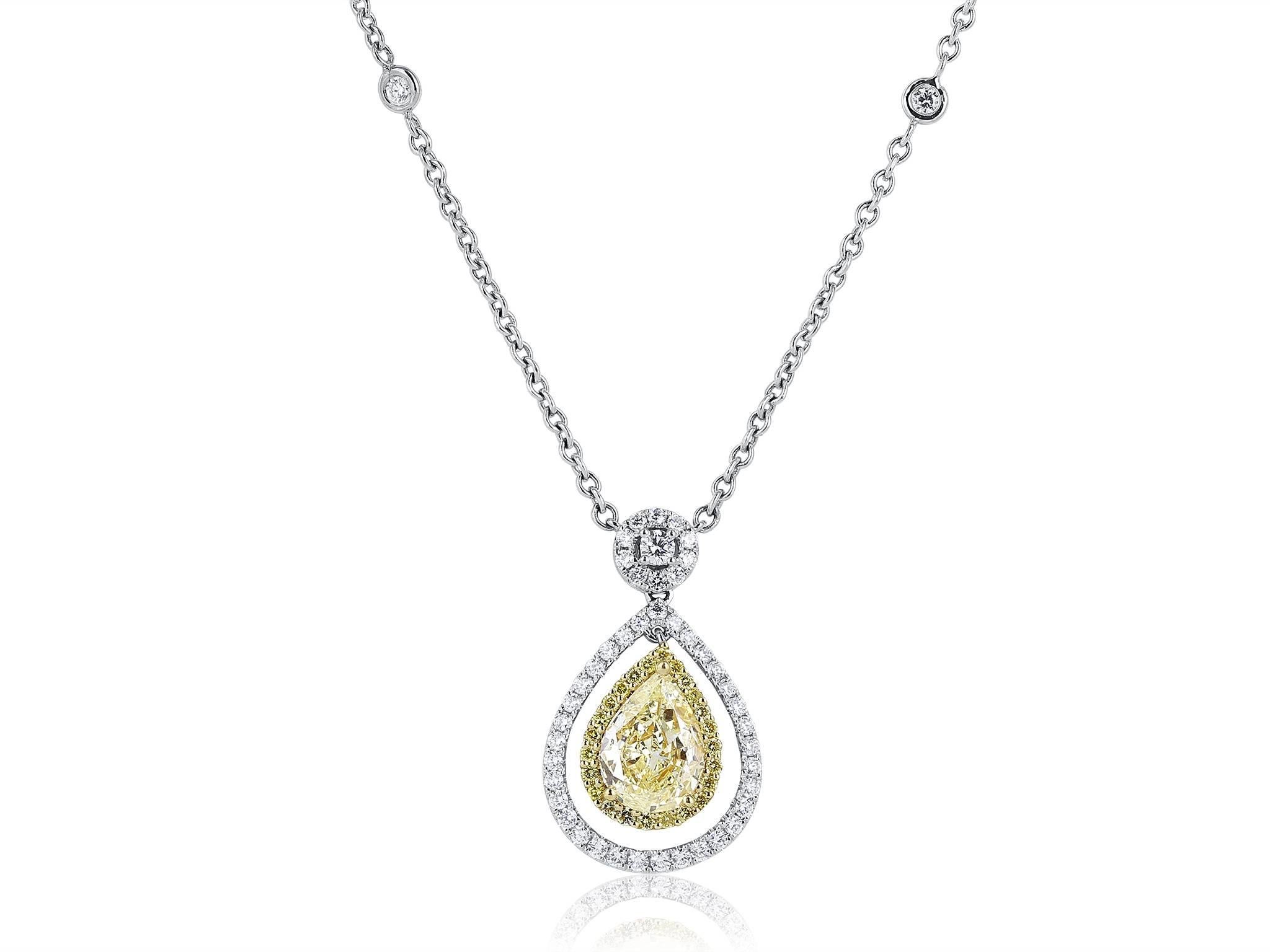 Two tone 18 karat white & yellow gold pendant consisting of 1 pear shape canary diamond weighing 2.02 carats set with 1.01 carats total weight of colorless full cut diamonds & .26 carats total weight of full cut canary diamonds.