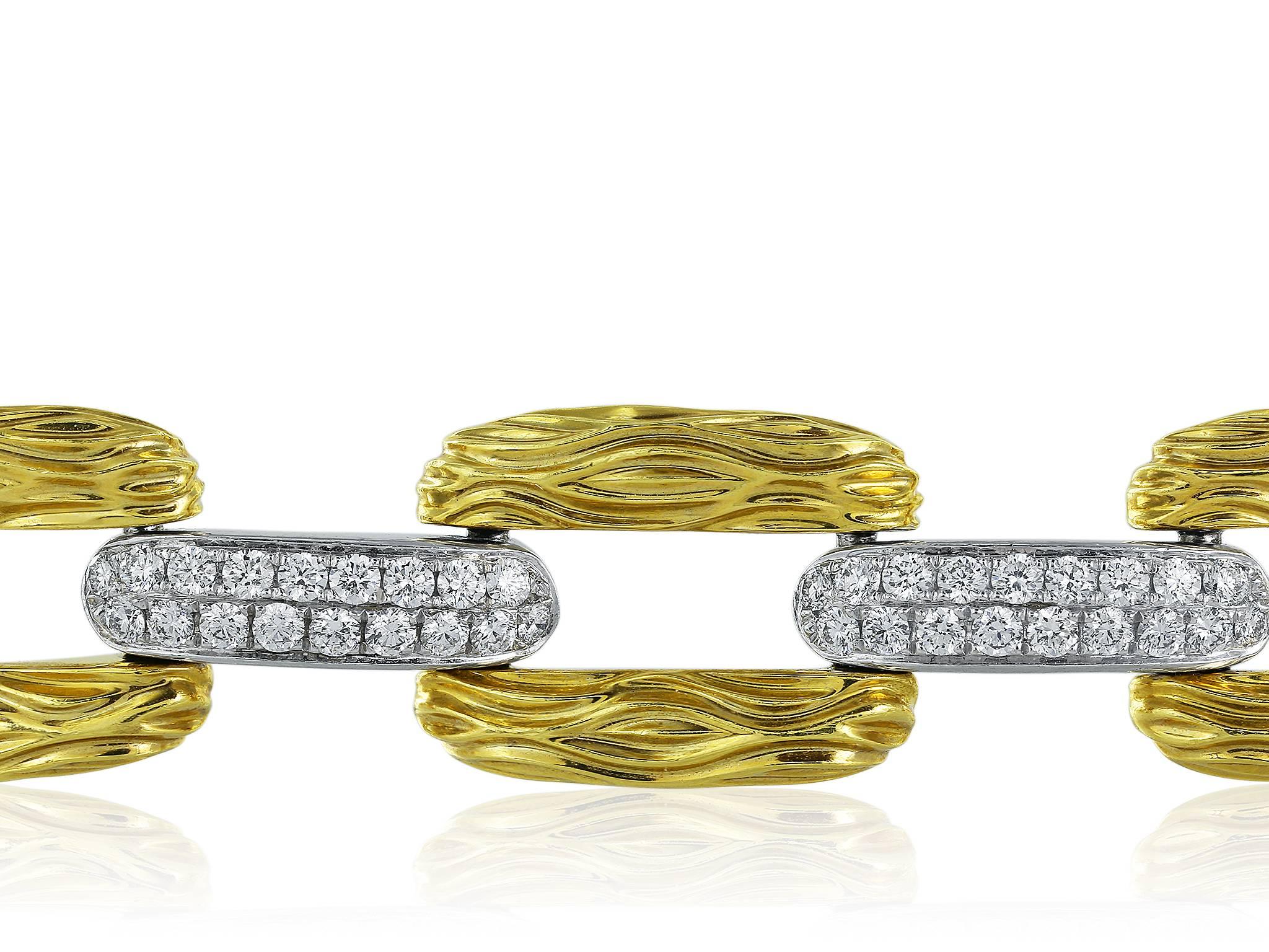 18 karat two tone diamond link bracelet consisting of textured yellow gold links with white gold pave diamond stations having a total weight of 1.93 carats with a color and clarity of G-H/VVS2 respectively.  