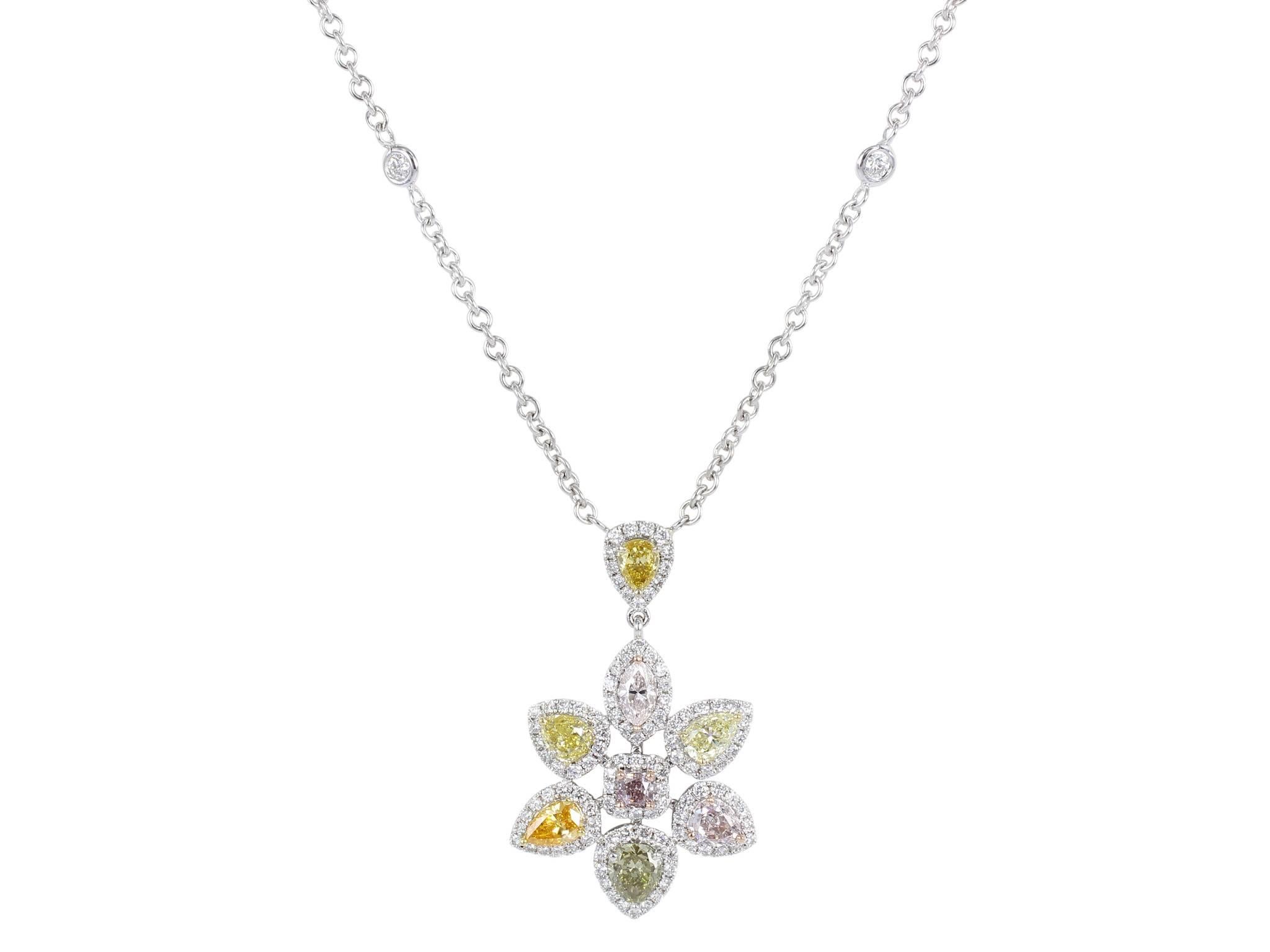 18 karat white gold floral style pendant consisting of 8 pear shape and radiant cut natural fancy color diamonds having a total weight of 2.63 carats set with 1.21 carats total weight of round brilliant cut diamonds.