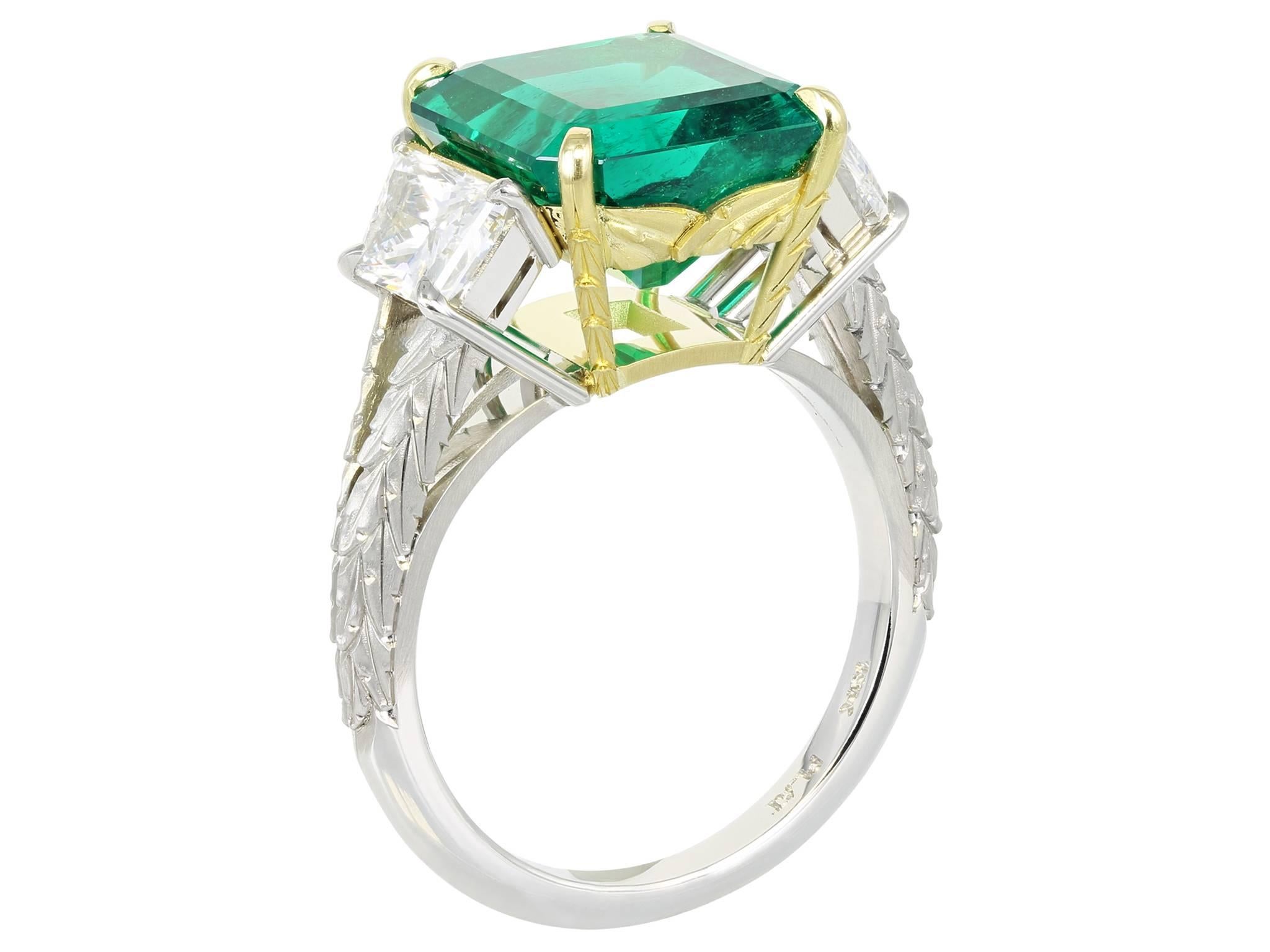 Platinum and 18 karat yellow gold custom made 3 stone ring consisting of 1 square emerald cut Colombian emerald weighing 5.00 carats, measuring 10.94 x 10.03 x 6.49mm the center stone is flanked by 2 brilliant cut trapezoid diamonds having a total