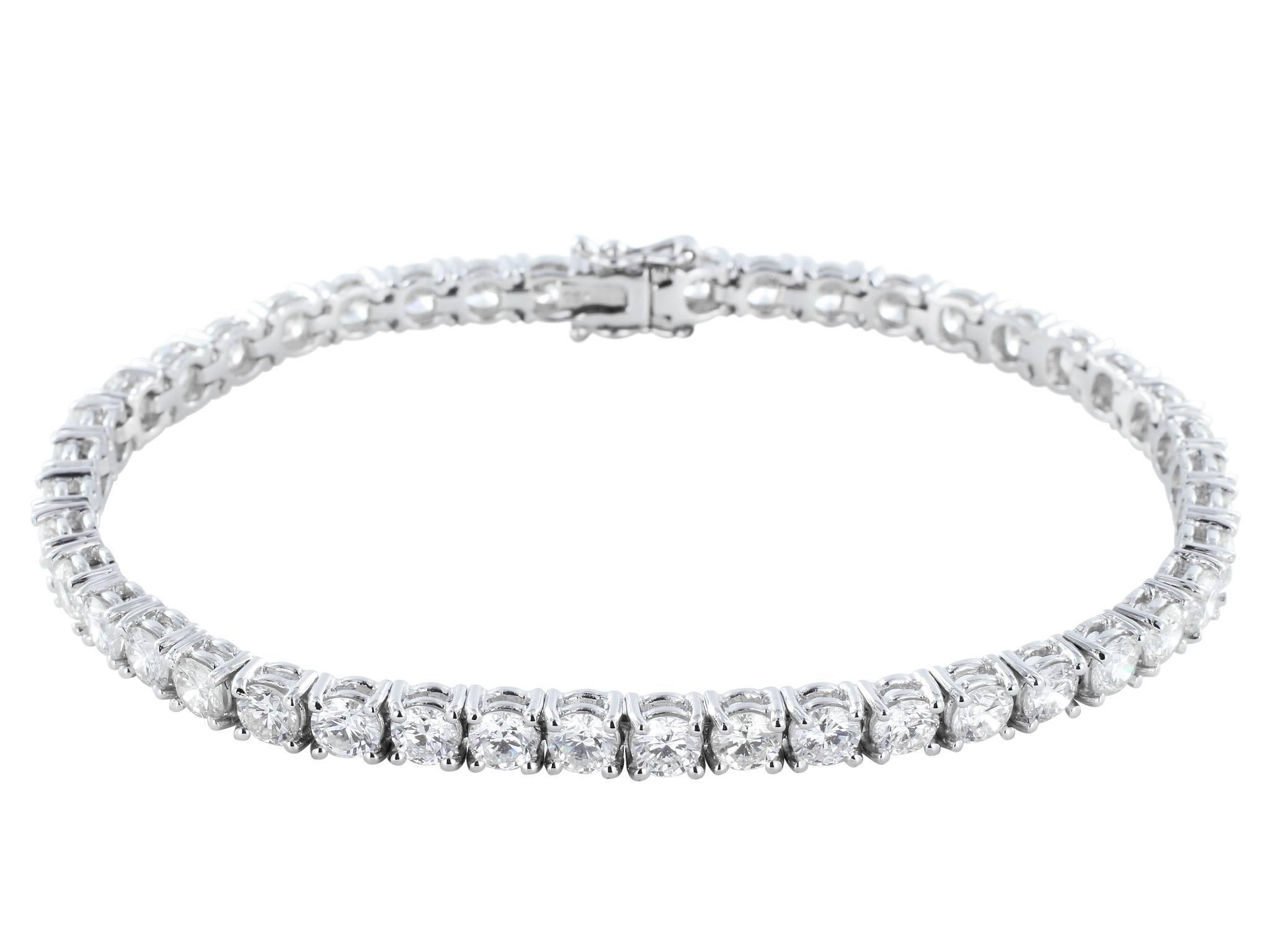 18 karat white gold diamond tennis bracelet consisting of 7.59 carats total weight of round brilliant cut diamonds.