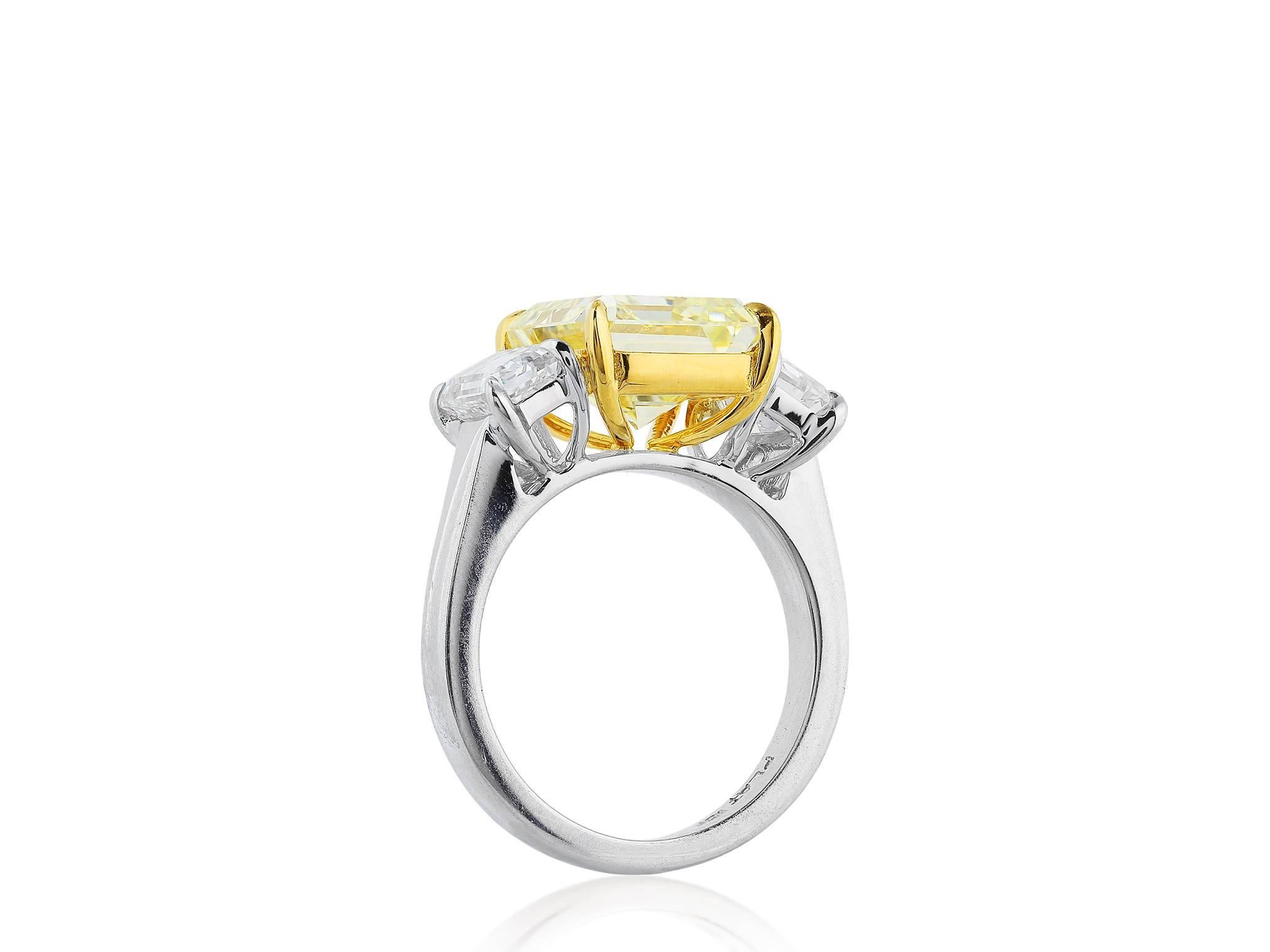Platinum and 18 karat yellow gold consisting of 1 emerald cut canary diamond weighing 5.28 carats having a color and clarity of FY/SI1 with GIA certificate #2165195114, the center stone is flanked by 2 emerald cut diamonds having a total weight of