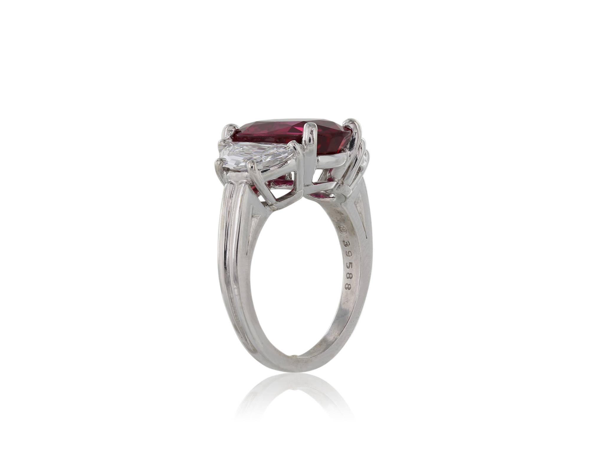 Platinum oval ruby and diamond ring set with one l Thai ruby weighing 4.15 carats and 2 half moon diamonds weighing 1.41 carats with a color and clarity F/G VS2 respectively, signed Oscar Heyman Brothers.