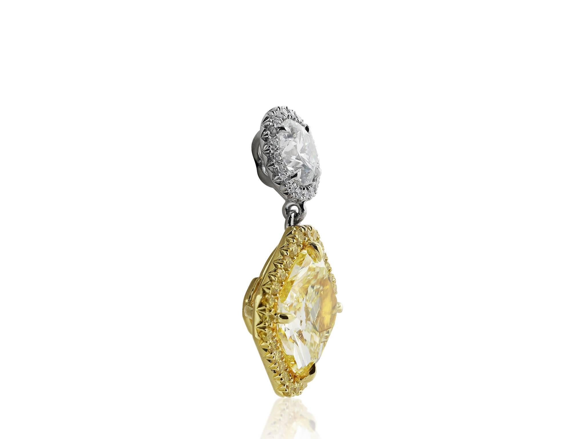 Platinum and 18 karat yellow gold drop earrings consisting of 1 radiant cut canary diamond weighing 2.67 carats with GIA color only certificate #10733383, and 1 radiant cut canary diamond weighing 2.72 carats with GIA certificate #10853435. The