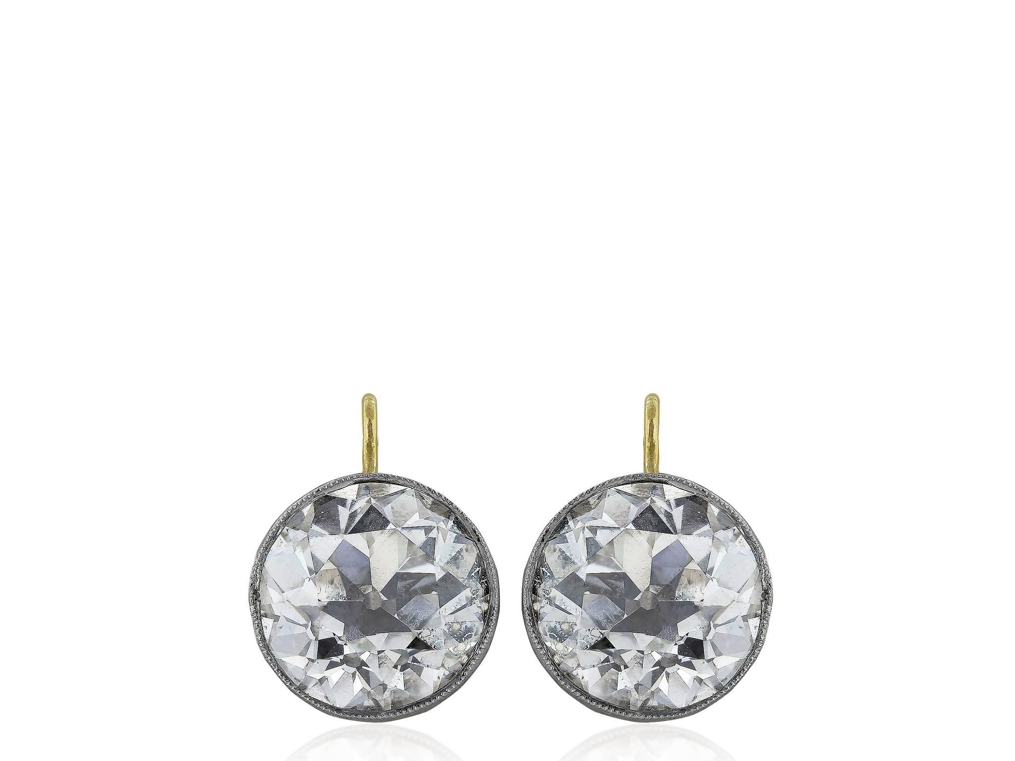 Platinum and 18 karat yellow gold vintage style drop earrings consisting of 1 Old European cut diamond weighing 3.06 carats having a color and clarity of J/VS2 with GIA certificate #1162042994 and 1 Old European cut diamond weighing 3.05 carats