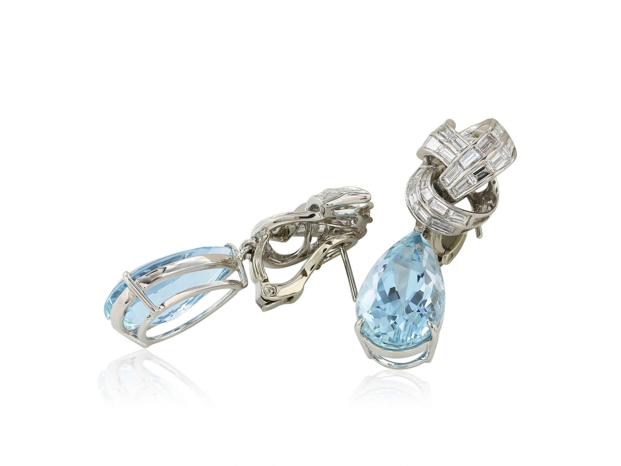 Platinum Pear shape Aquamarine and diamond drop earrings. Consisting of 2 PS Aquamarines measuring 11.50x18.00.00 MM and weighing approximately 14 carats capped by 52 Baguette diamonds having a total weight of approximately 2.75 carats