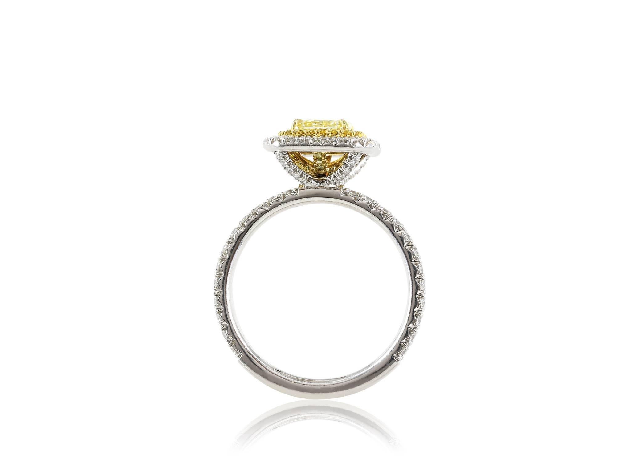 Platinum and 18 karat yellow gold hand made ring featuring 1 fancy yellow radiant diamond weighing 1.03 carats, measuring 5.42 x 5.36 x 3.63 mm with a VS1 clarity and with GIA certificate 2135696318 surrounded by .17 full cut yellow diamonds and .70