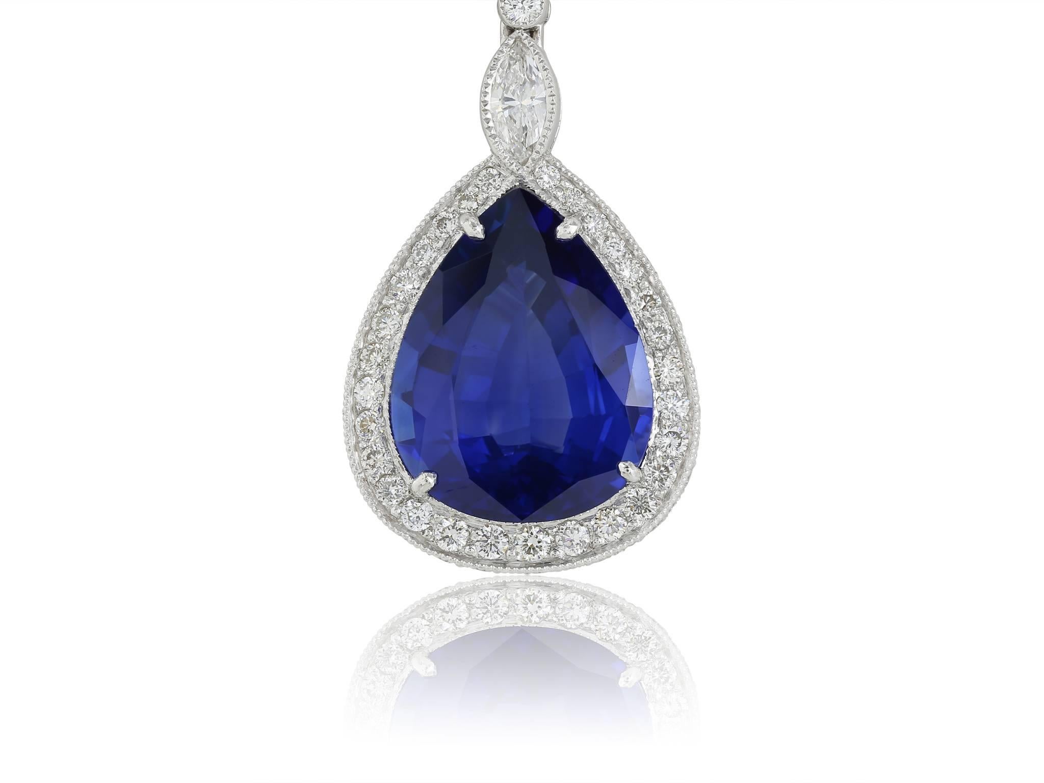 Platinum, diamond and sapphire drop earrings.  Consists of 2 pear shaped  fine blue ceylon sapphires t.w.= 12.10 carats.  Surrounding sapphires are small round brilliant cut diamonds attached to a bezel set round diamond.  Total diamond weight 1.81